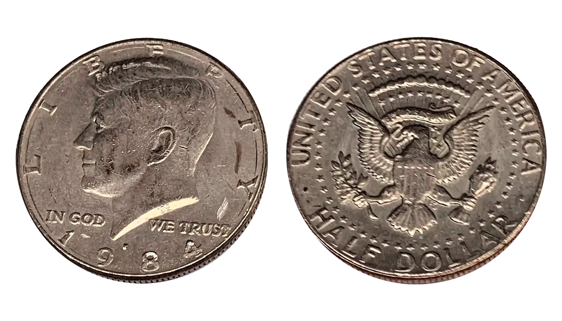 1984-P Kennedy half dollar broadstruck error coin with flat expanded rim wider than normal diameter