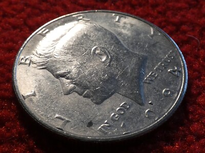 1984 Kennedy half dollar rotated die error showing reverse rotated approximately 90 degrees from normal medal alignment