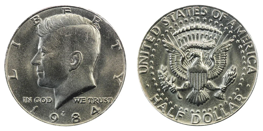 Collection of 1984 Kennedy half dollars from Philadelphia and Denver mints showing various grades from circulated to uncirculated